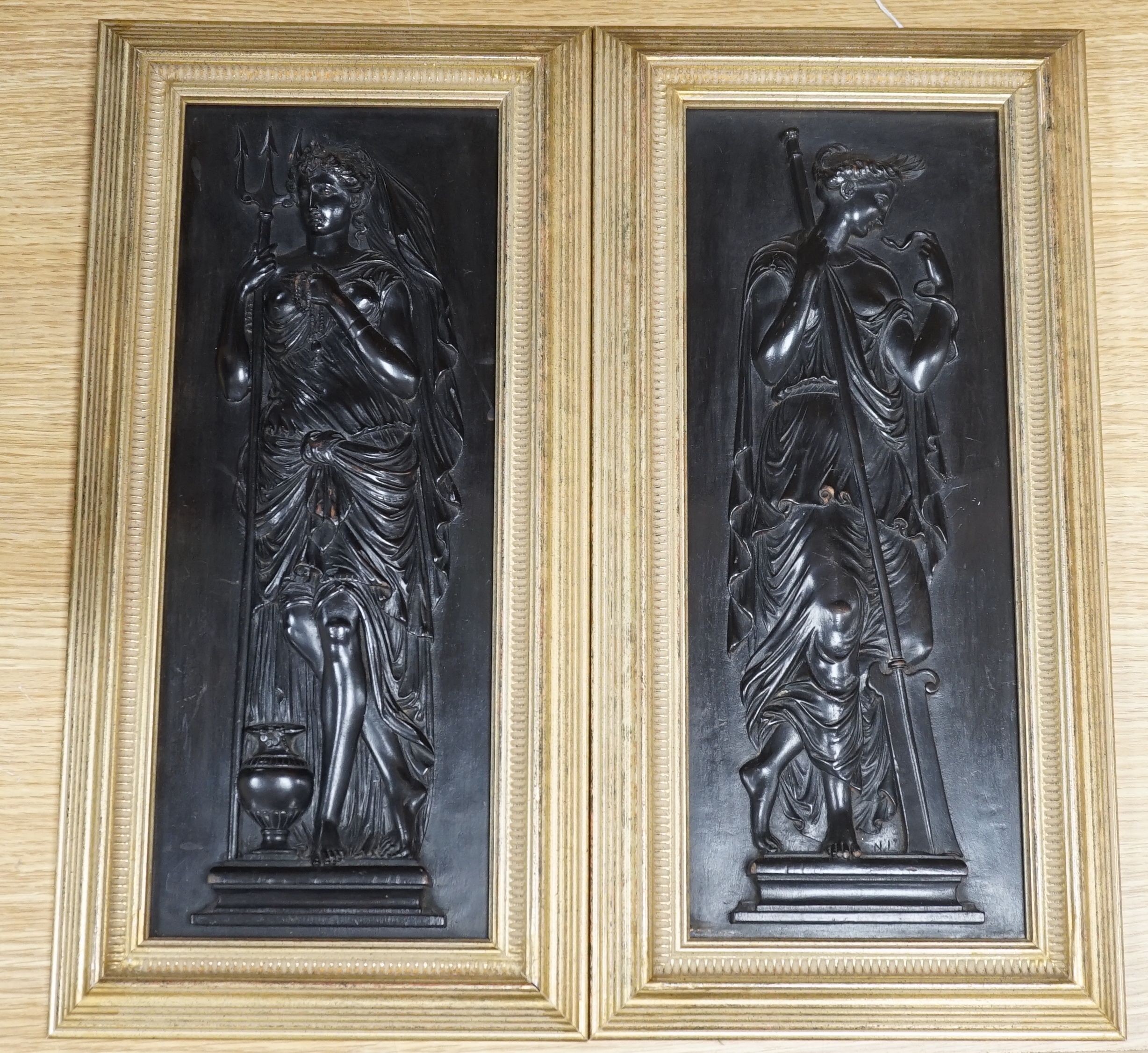 A pair of carved and ebonised wood panels of Grecian muses, by N. Laval. c.1830, framed